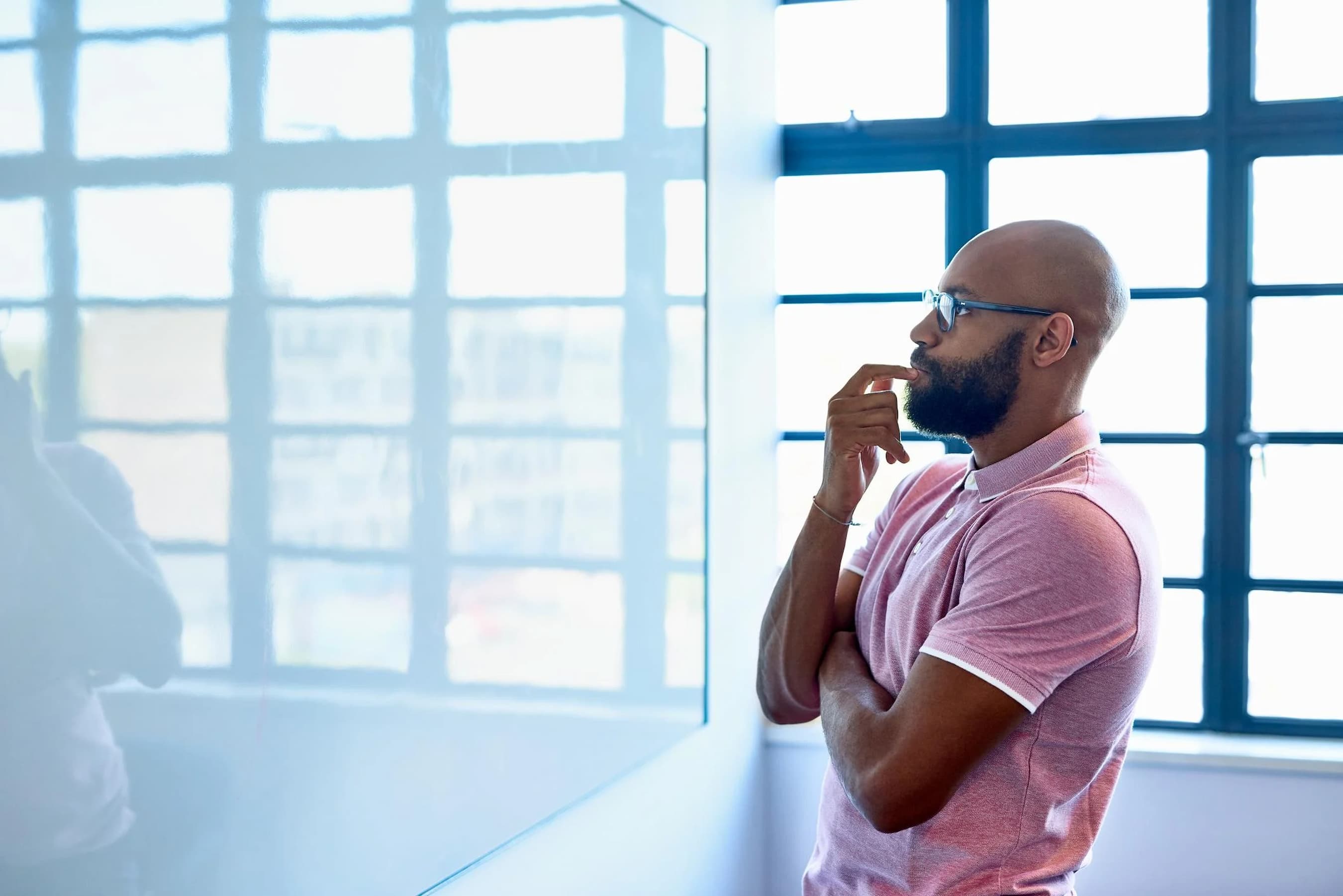a-man-starting-at-a-whiteboard-figuring-out-how-to-fix-a-lack-of-focus-at-work
