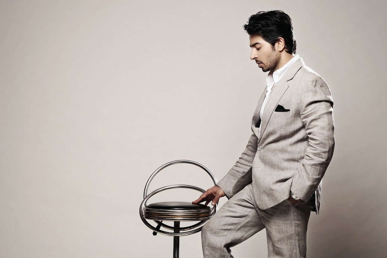 business-man-posing-at-a-chair-business-skills