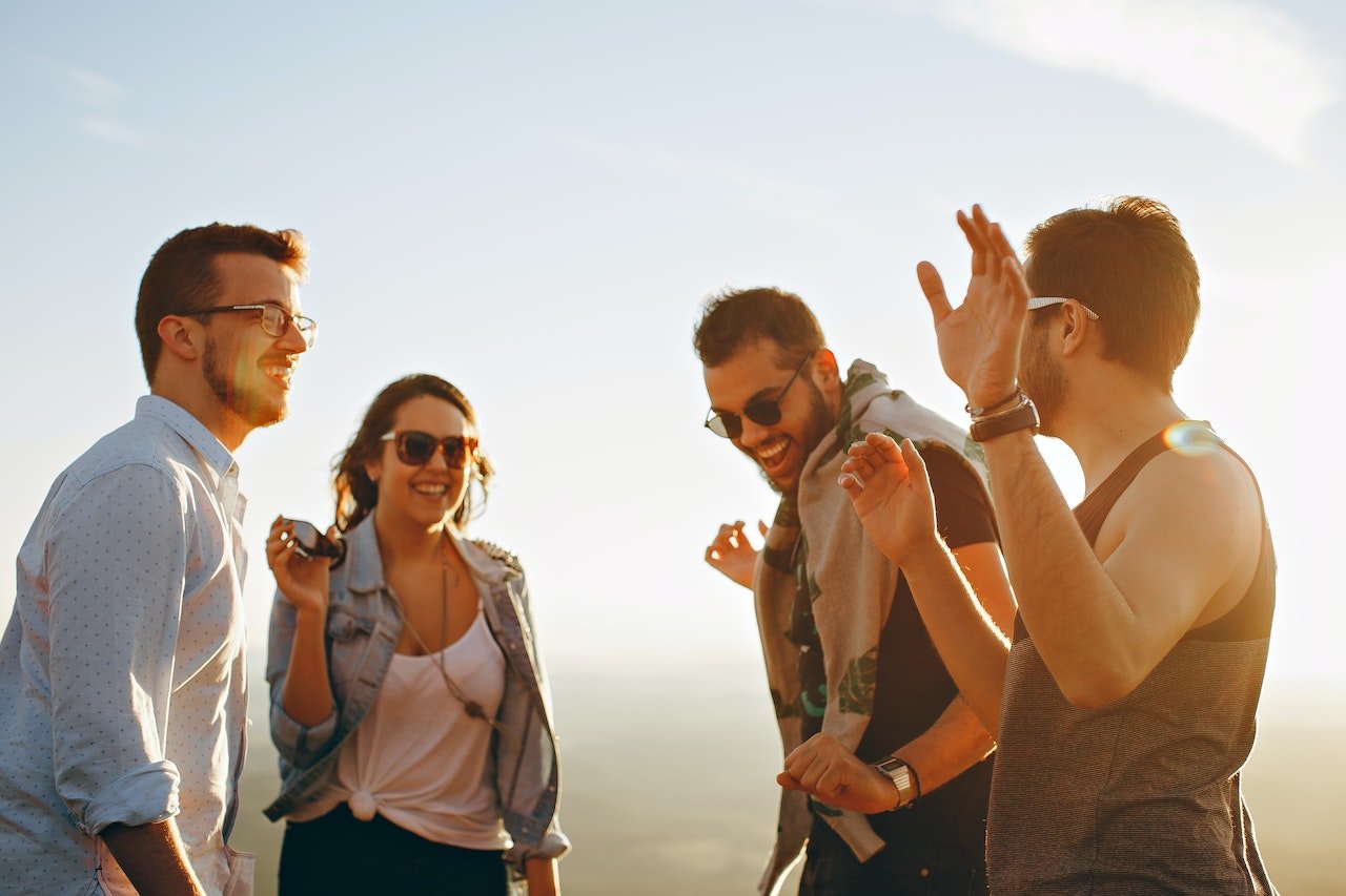 Four-friends-laughing-while-watching-sunset-autonomy-in-a-relationship