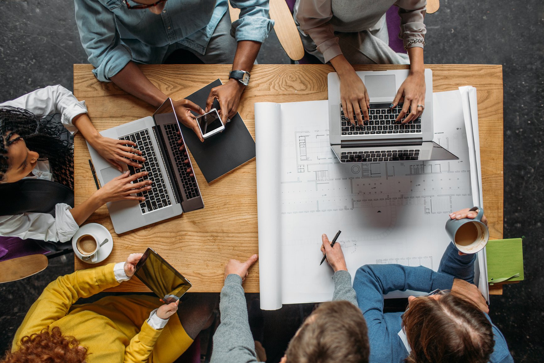 Overhead-shot-of-a-group-of-business-people-having-a-meeting-working-smarter-not-harder
