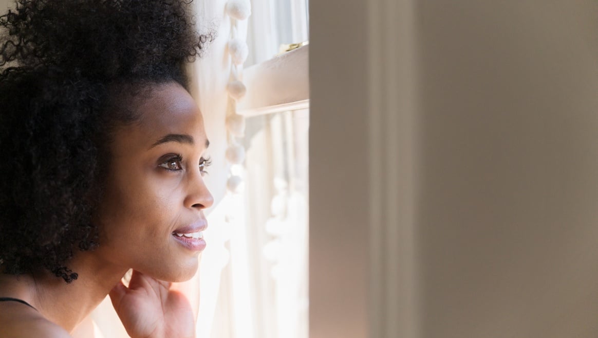 woman looking out window - changing careers