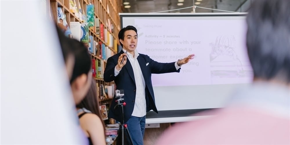 man presenting in crowd - improve public speaking