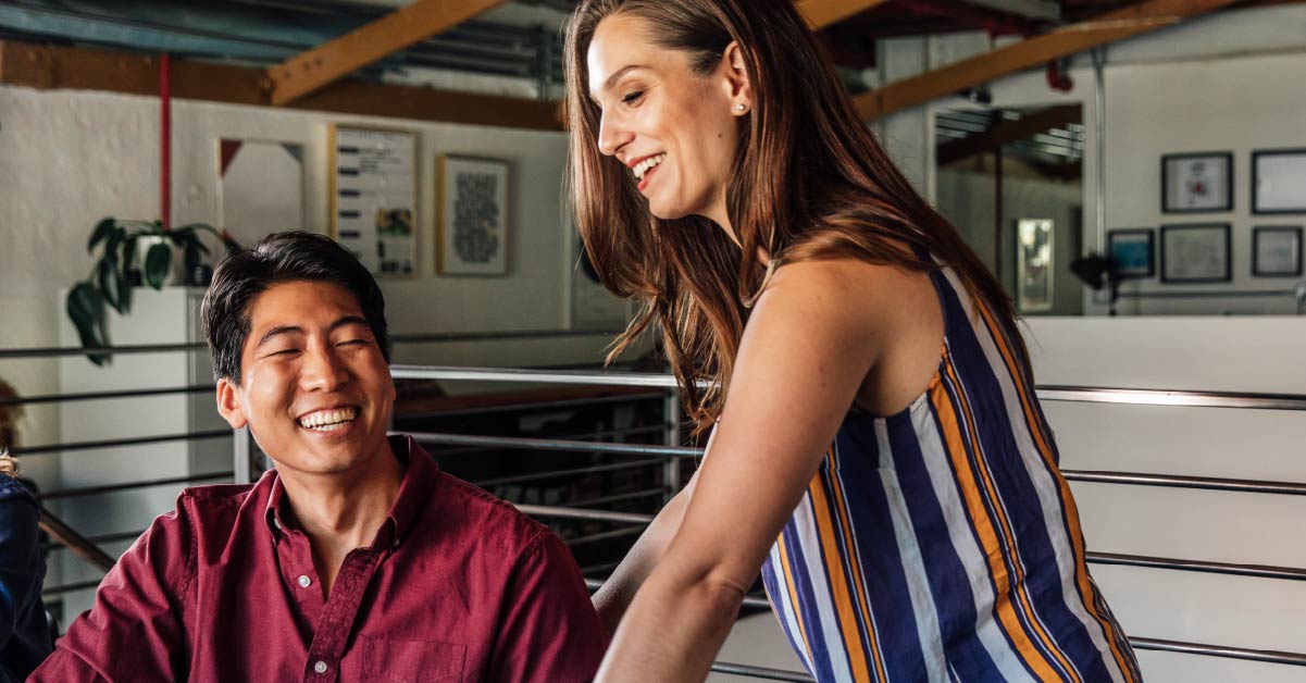 woman-and-man-laugh-together-at-work-inner-work-makes-better-leaders