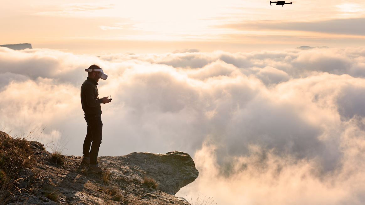 man-in-VR-goggles-stands-on-edge-of-cliff-outsmart-innovators-bias