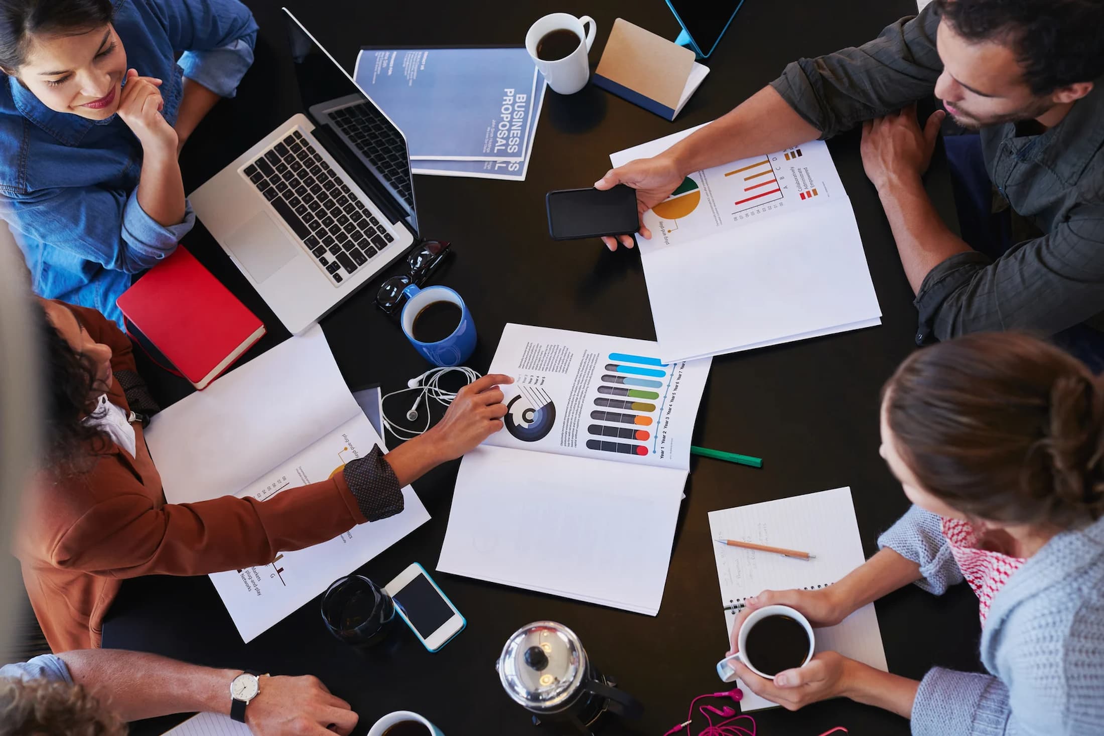 overhead-view-of-people-discussing-qualities-of-an-entrepreneur