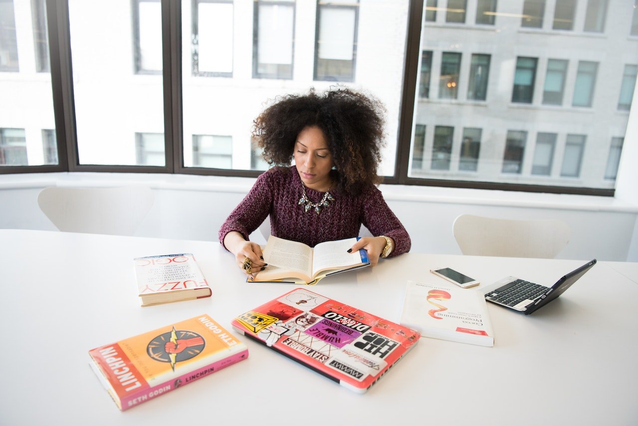 woman-sitting-in-office-alone-reading-book-personal-space