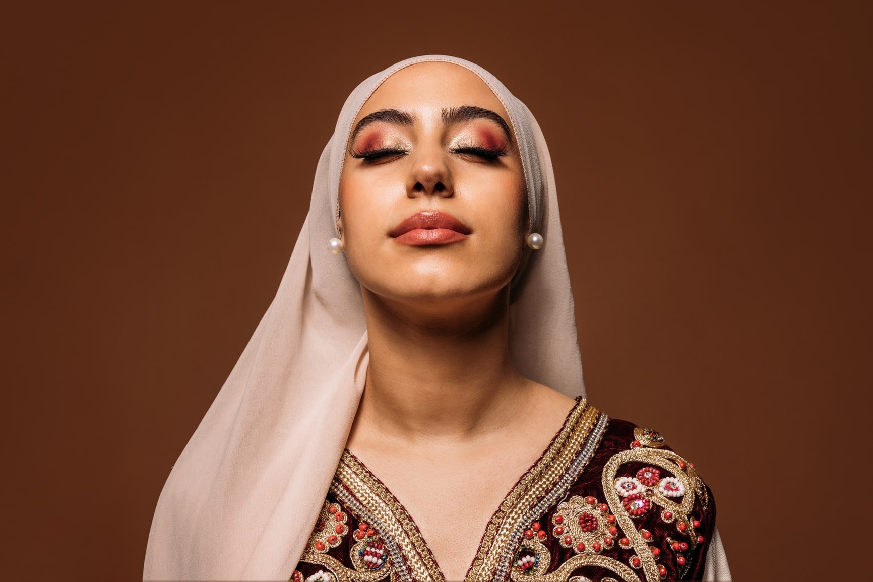 woman with head scarf and eyes closed - inner work