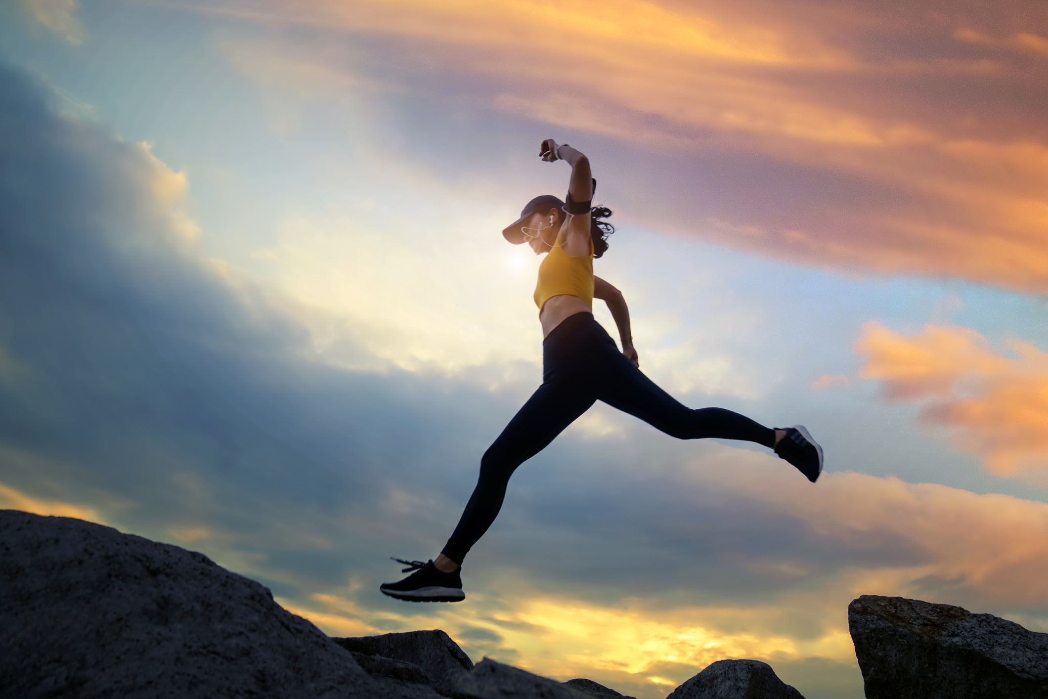 Woman-runs-and-jumping-on-mountain-ridge-at-sunset-exercise-and-mental-health