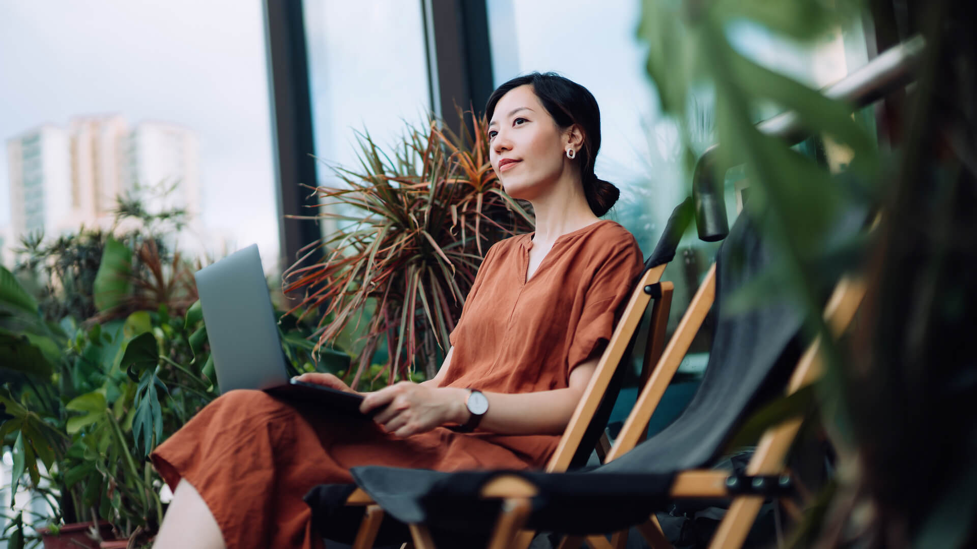 woman-sitting-with-laptop-plants-personal-well-being-at-work