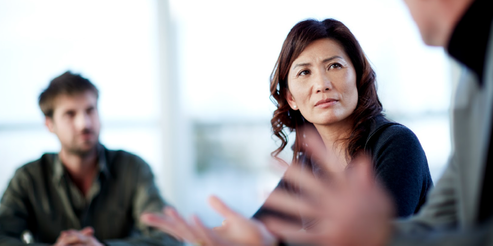 woman looking at co-worker - constructive criticism 